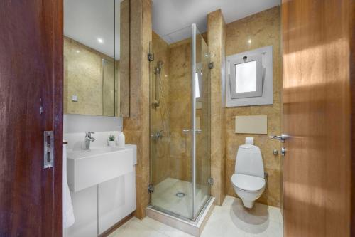 a bathroom with a toilet and a sink and a shower at Berengaria Court - Sea Views 2bdr Apartment in Limassol