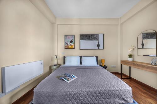 a bedroom with a large bed with a tv at Berengaria Court - Sea Views 2bdr Apartment in Limassol