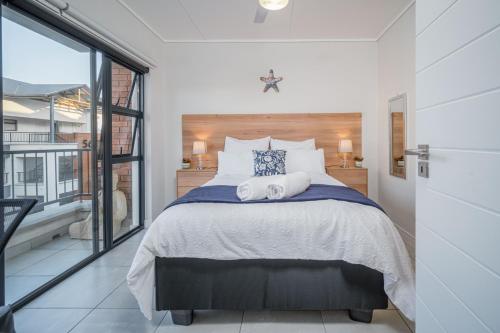 a bedroom with a bed with two towels on it at 366 Ballito Hills in Ballito