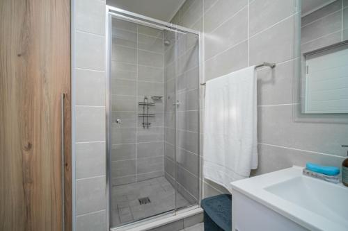 a shower with a glass door in a bathroom at 366 Ballito Hills in Ballito