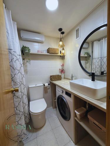 a bathroom with a sink and a washing machine at Rasmia Canfranc Estación in Canfranc-Estación