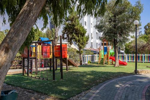 a park with a playground with a slide at Berengaria Court - Sea Views 2bdr Apartment in Limassol
