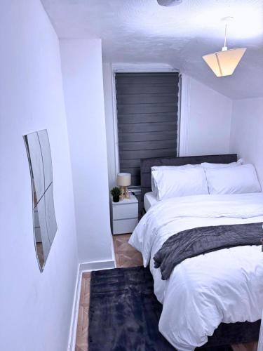 a bedroom with a large bed with a black headboard at House for 8 in Gillingham close to train station in Gillingham