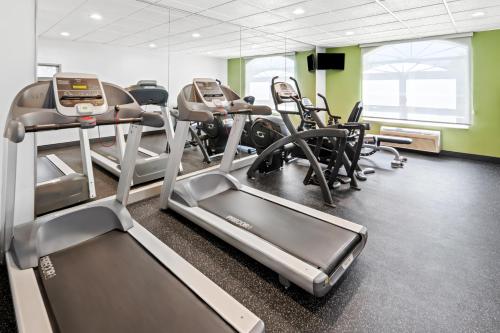 a gym with treadmills and elliptical machines at Spark by Hilton in Woodbridge