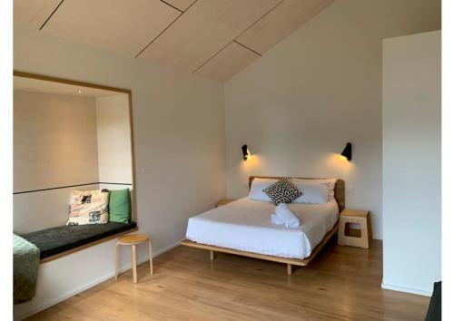a small bedroom with a bed and a mirror at Perch Lorne in Lorne