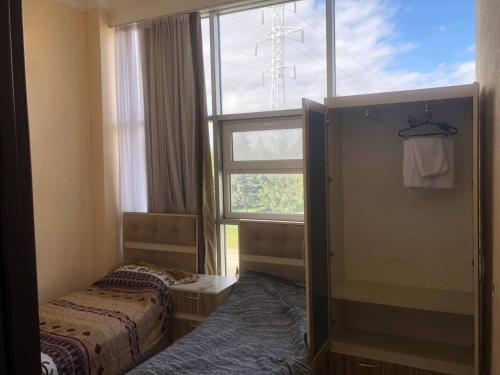 a room with two beds in front of a window at İzmir can hotel in Baku