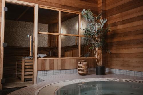 a room with a tub with a potted plant at Home Hotel Kompaniet in Nyköping