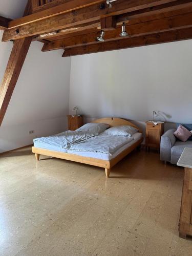 a bedroom with a bed in the corner of a room at Bioweingut Glaser in Hainfeld