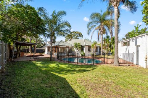 a house with a swimming pool in a yard at Large 5BR Home-Pool-BBQ-5 CarPark-Central Location in Melbourne