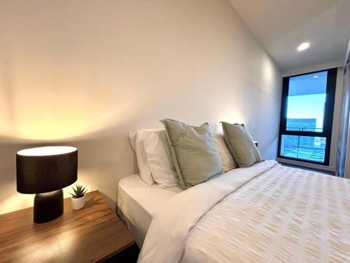 a bedroom with a large bed with a window at Full of Fun shopping 1BR stay at Clayton in Clayton North