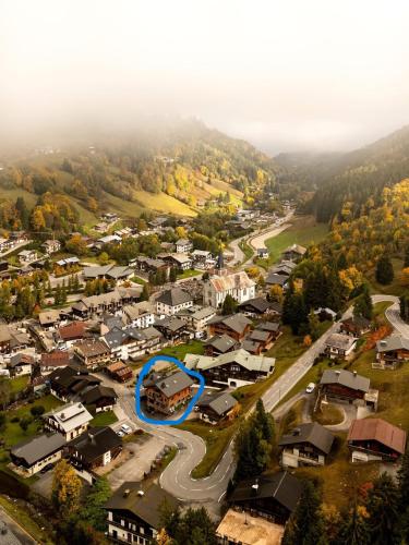 an aerial view of a small town with a blue circle at CHALET CHARMING BED and BREAKFAST in Les Gets