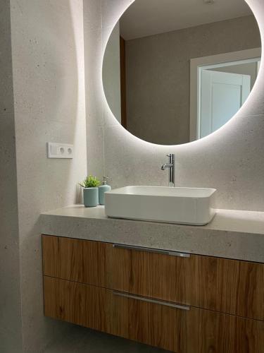 a bathroom with a sink and a mirror at Apartament N32 in Garwolin