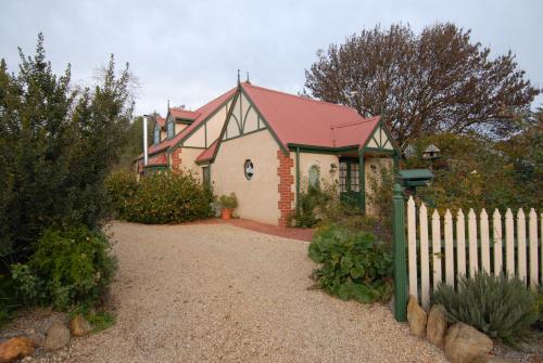 a house with a fence in front of it at The Dove Cote in Tanunda