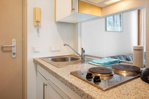 a kitchen with a sink and a counter top at Haus Stiegeler - Gottfried Beck in Freiburg im Breisgau