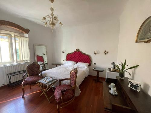 a bedroom with a bed and a table and chairs at La Casa di Dante Fiesole in Trespiano