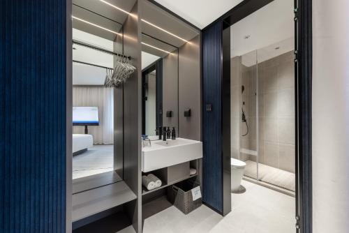 a bathroom with a sink and a toilet at Shanghai Jiading Pingcheng Road Atour Light Hotel in Shanghai