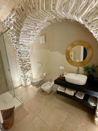 a bathroom with a sink toilet and a mirror at Masseria Finigrini Luxury in Corato