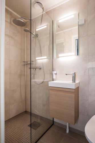 a bathroom with a sink and a shower at 8 Seasons Hotel in Varangerbotn