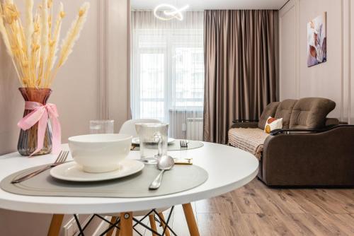 a living room with a white table and a couch at Квартира в ЖК бизнес класса in Almaty