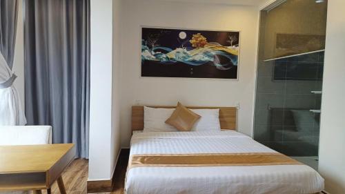 a bedroom with a bed and a glass shower at ROMANCE HOTEL DALAT in Da Lat