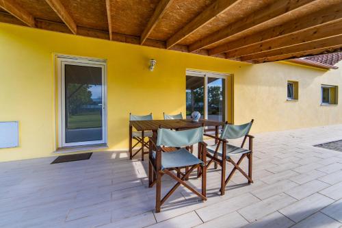 a patio with a wooden table and chairs at Casa do Sobreiro in Cantanhede
