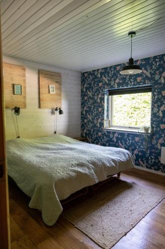 a bedroom with a bed in a room with a window at Stilbjerg Sleep&Hygge in Varde