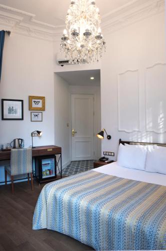 a bedroom with a bed and a chandelier at Rodosto Hotel in Tekirdag