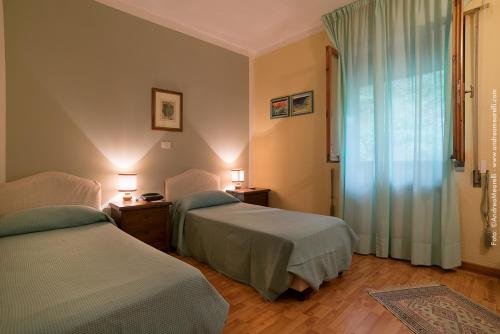 Postel nebo postele na pokoji v ubytování Hotel Relais Valle Orientina