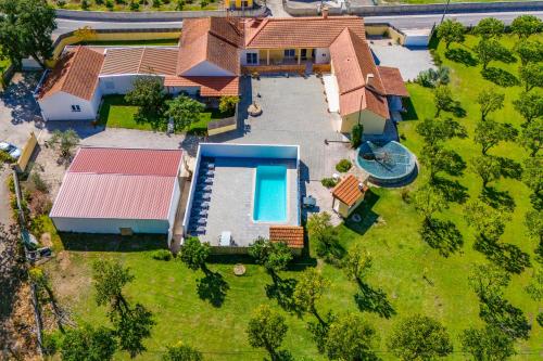 an aerial view of a house with a swimming pool at Casa do Sobreiro in Cantanhede