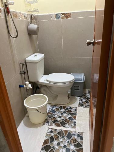 a bathroom with a toilet and a sink at Subangan bayud3, Burgos central location in Burgos