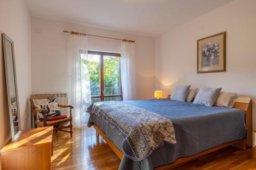 a bedroom with a large bed and a window at Maria Buzet 1 with Shared Pool in Buzet
