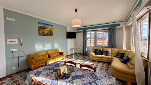 a living room with two couches and a table at Mondello SunSea House in Mondello