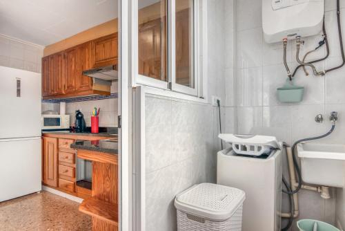 a small kitchen with a sink and a refrigerator at Brooklyn in Oliva