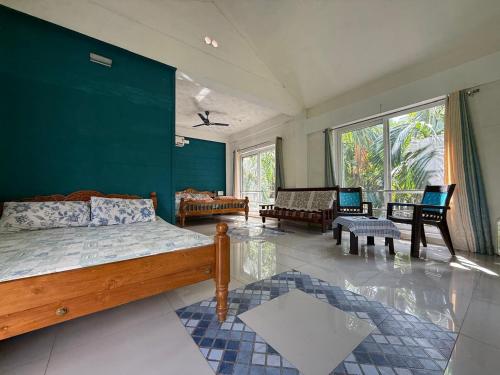 a bedroom with a bed and a living room at Murthi's Farm House in Coimbatore