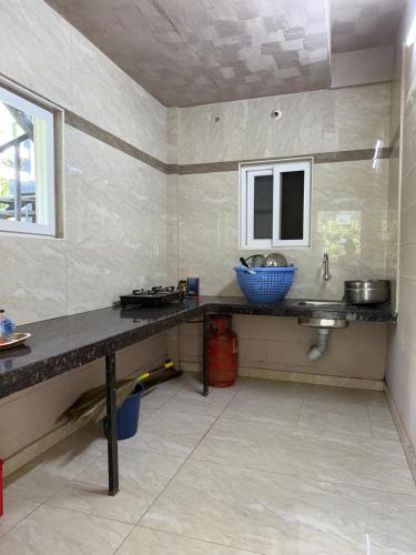 a kitchen with a counter and a sink at Murthi's Farm House in Coimbatore