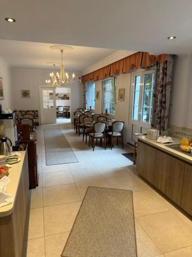 a kitchen and dining room with tables and chairs at Rixbecker Alpen - Hotel Koch in Lippstadt