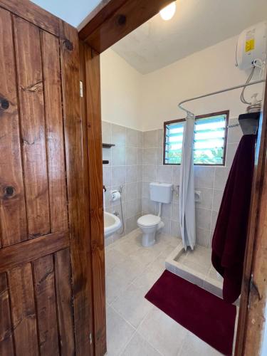 a bathroom with a toilet and a sink at watamu New Arcade Comfort Suite in Watamu