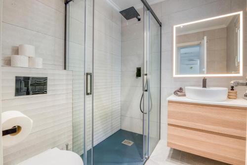 a bathroom with a glass shower and a sink at Casa Julieta in Benitachell