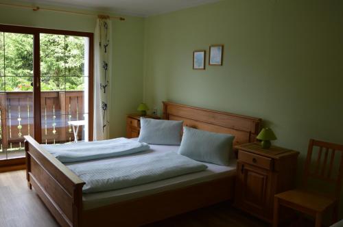 a bedroom with a large bed with a window at Apartmány U Vaců in Železná Ruda