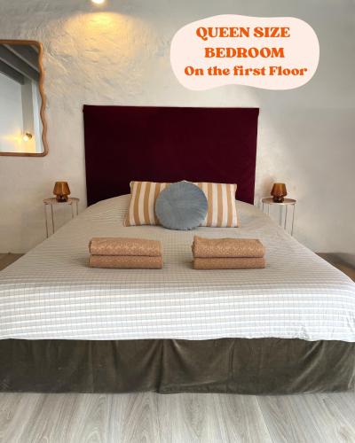 a large bed with two pillows on top of it at Cocon Familial Proche Disneyland Paris in Quincy-Voisins