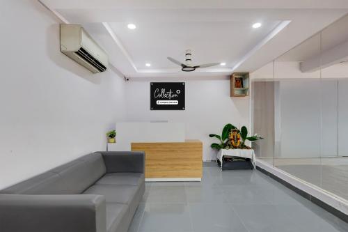 a living room with a couch and a tv at Super Collection O Dr. NTR University Of Health Sciences Formerly Hotel V Elite in Vijayawāda