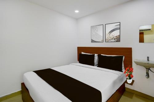 a bedroom with a large bed and a sink at Super Collection O L.B Nagar Metro Station Formerly D N Groups in Surūrnagar