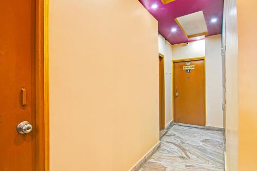 an empty hallway with a room with a purple ceiling at Super Hotel O Rishra Railway Station Formerly Green Guest House in Khardah