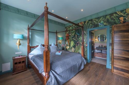 a bedroom with a canopy bed and a bathroom at Gästehof Cafe im Schafstall in Barsinghausen