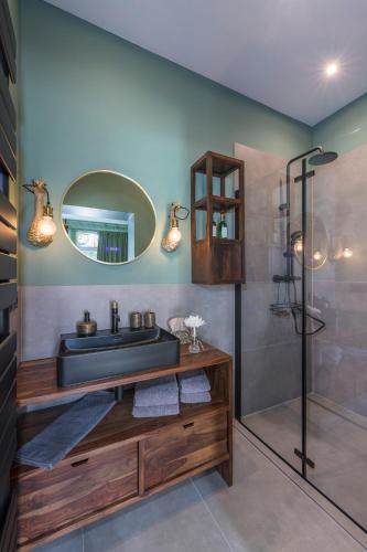 a bathroom with a sink and a shower at Gästehof Cafe im Schafstall in Barsinghausen