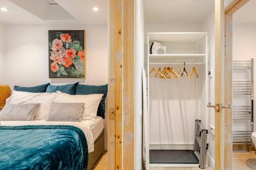 a bedroom with a bed and a closet at Skylight Studio near Hospital in Gaywood