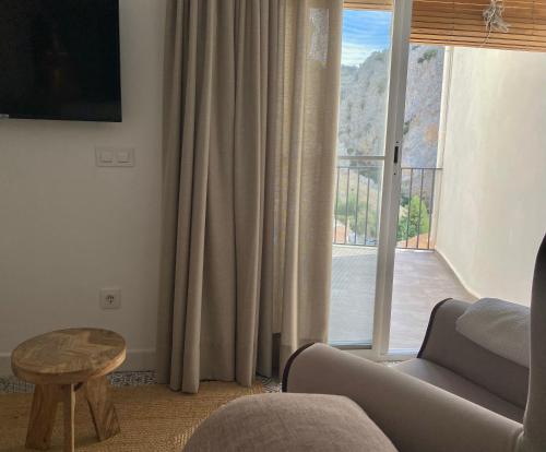 a living room with a couch and a large window at La Luz in Zuheros