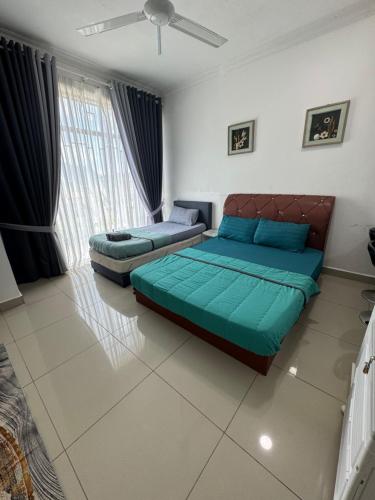a bedroom with two beds and a ceiling fan at D'Royale NH Homestay Kompleks Mutiara Gua Musang in Gua Musang