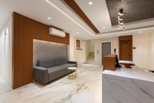 a living room with a couch and a table at Hotel Rajshree Suites in Ujjain