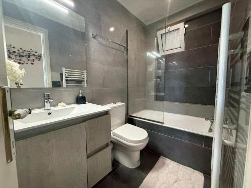 a bathroom with a toilet and a sink and a shower at Anna's Seaside Apartment - In front of the beach in Kos Town